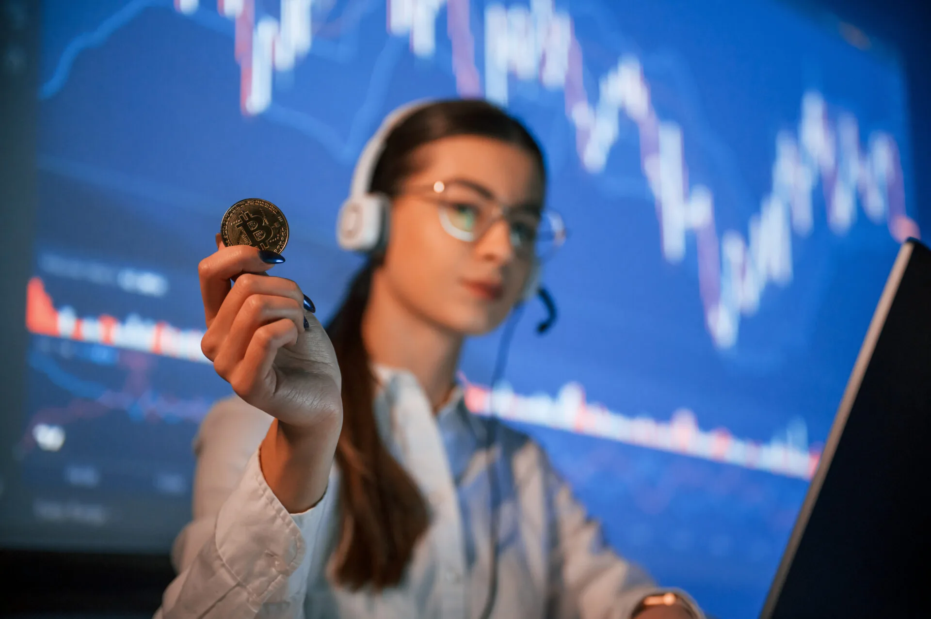 Woman Holding Bitcoin with Financial Chart Background