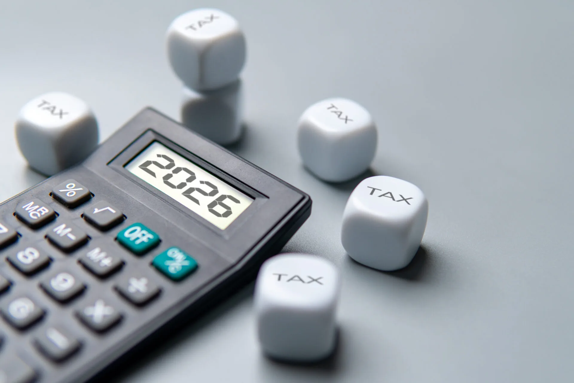 Tax Planning with Dice and Calculator Displaying 2026