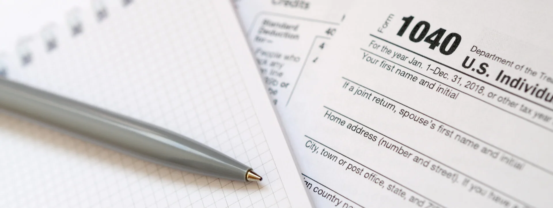 Tax Form 1040 and Pen for Financial Planning